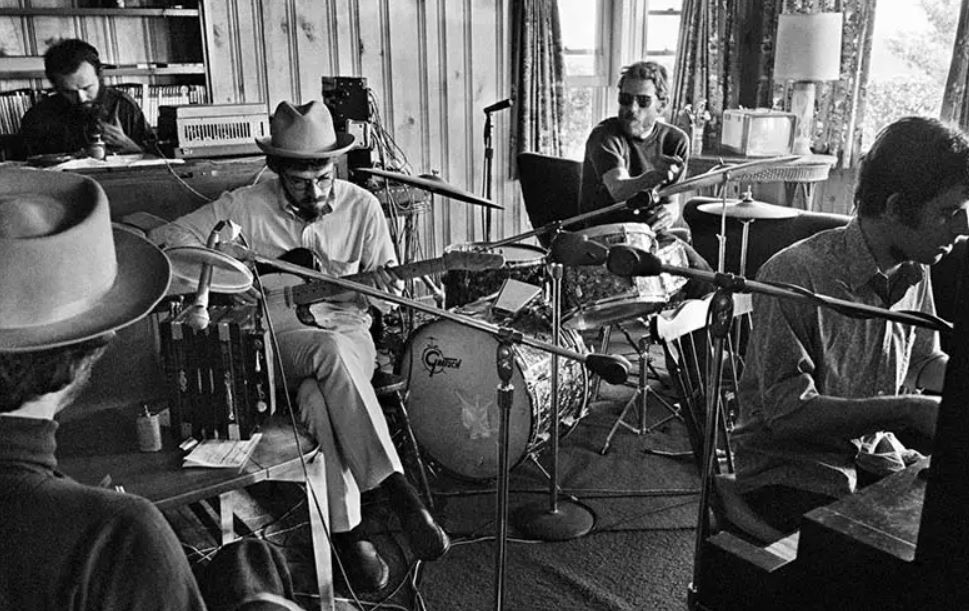 A young Bob Dylan is recording with his fellow musicians.