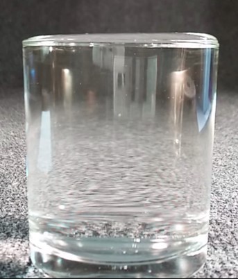 A glass with water to the brim.